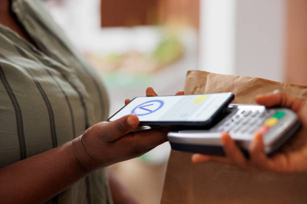 istock African american woman paying contactless 1871297285