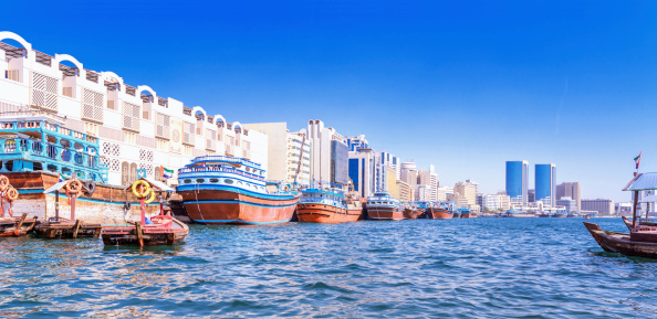 Panoramic view over the Dubia Creek with traditional dhows lined up.