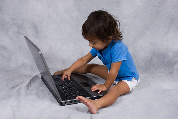 istock Little girl on the computer 187130162