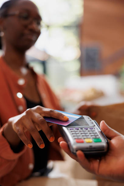 istock Black woman paying with card 1871303503