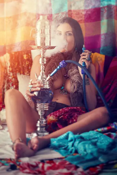 Photo of hippie girl smoking water pipe