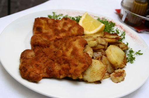A northern Italian version of a breaded veal cutlet or Wiener schnitzel with pan fried sliced potatoes.