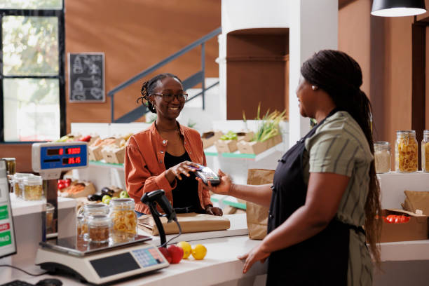 istock Two women at a local market checkout 1871306604