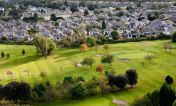 detached houses at Prestonfield golf course with sand traps in Edinburgh UK