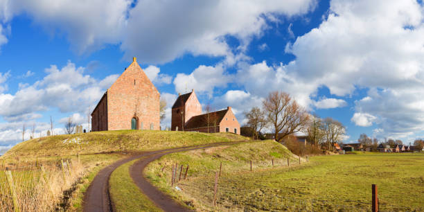 The old village of Ezinge in the northern province of Groningen. In The Netherlands, to protect villages from the nearby sea, houses were build on high man-made mounds, called a 'terp' or 'wierde' in Dutch. A seamlessly stitched panoramic image.