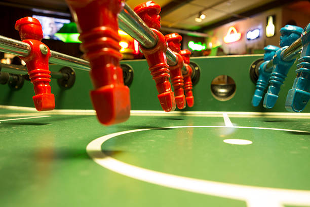 red and bllue Foosball players in a row Foosball players beines stock pictures, royalty-free photos & images