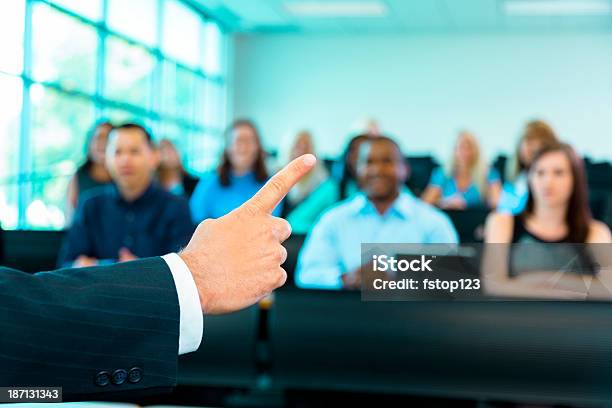 Education Professor Gestures To Students In Lecture Hall Stock Photo - Download Image Now