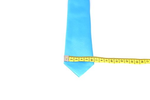 Necktie measuring scene with measurement tape on top of tie with white background, Width measurements