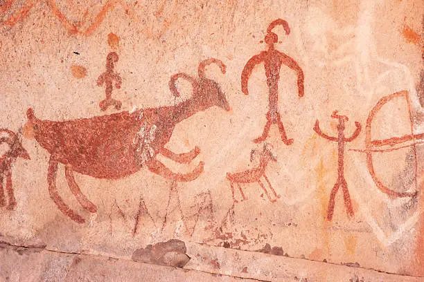 Pictograph rock art at the Palatki site in Loy Canyon, Arizona.  Most of the artwork is attributed to the Sinagua, who inhabited the area between 650AD and 1200AD, but in some cases artwork from other time periods is interspersed and overlayed with the Sinaguan.  More primitive etchings date as far back as 6000 years, while a few markings were made by ancestral Apache more recently (confirmed by tribal elders).  Pictographs are painted images, whereas petroglyphs are etchings performed by abrading the rock with the edge of another.  Pictographs at this site are typically in white, red and black, or kaolin, hematite and charcoal.  Archeologists believe that much of the art at the Palatki site relates to the dreamstate imagery of ancient Shamans.  This image depicts pictogaphs typical of the Sinaguan style.  Yavapai County, Arizona, 2013.