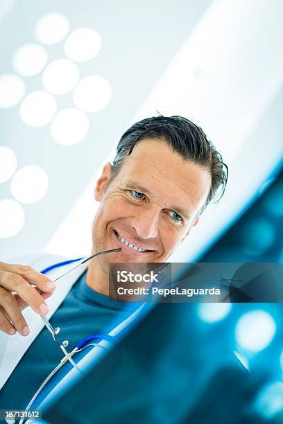 Doctor Checking Xray Stock Photo - Download Image Now - 30-39 Years, Adult, Built Structure