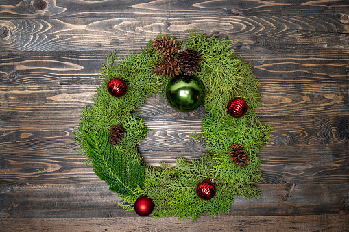 Making Christmas wreath on wooden table background. Christmas decoration concept