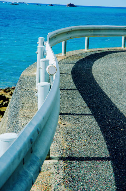 Shadow of the curved beach guardrail in Amami Oshima (Japan's largest island)
