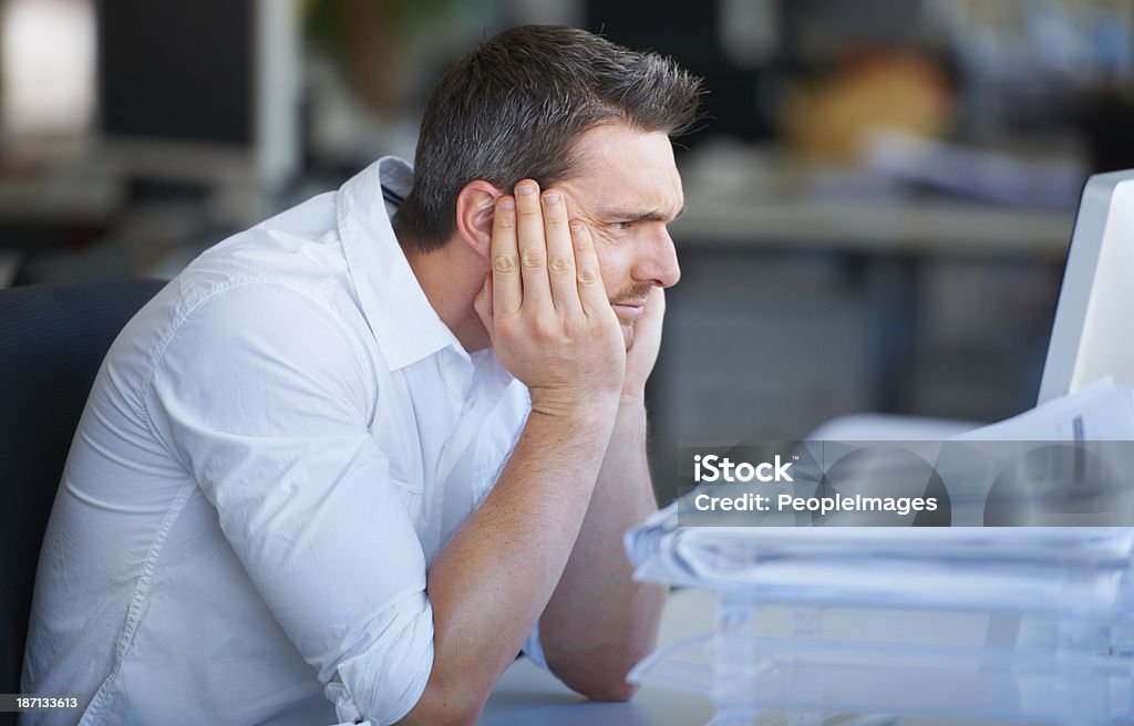 Work can be stressful A handsome businessman sitting with his head in his hands Adult Stock Photo