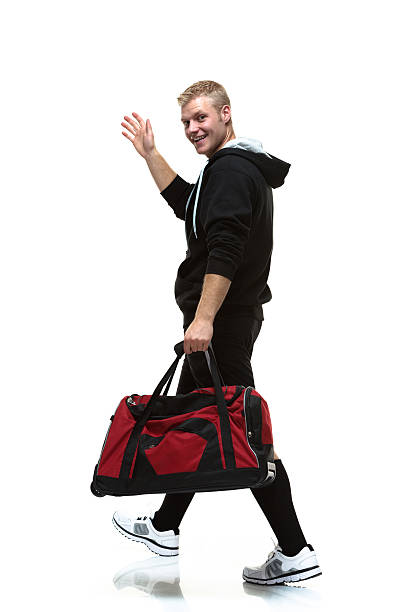 istock Young man holding gym bag 187133895
