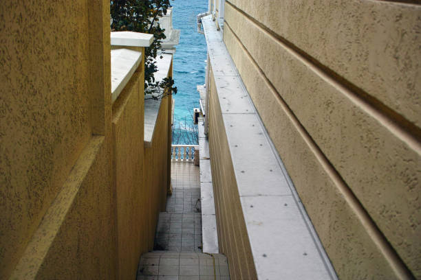 A beach exit cast concrete staircase with wooden handrails going uphill, Mossel Bay, South Africa