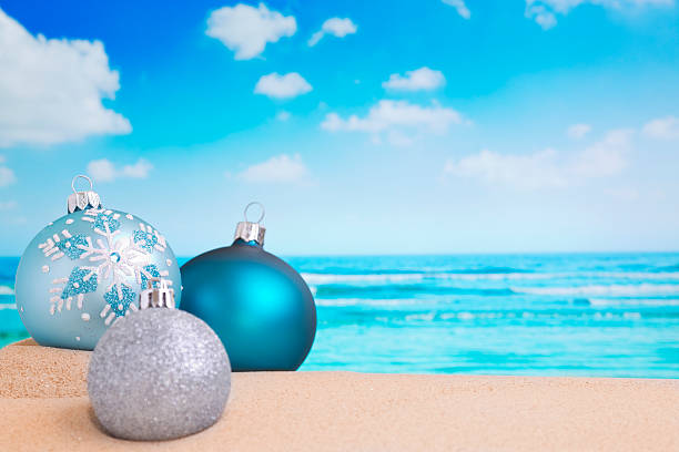 Christmas decorations on a beautiful beach with a turquoise ocean in the background.