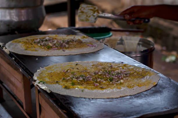 istock Dosa making at the road side veg restaurant or stall. 1871362096