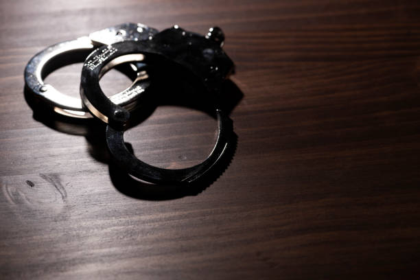 istock Handcuffs Placed in Dark Room 1871383038