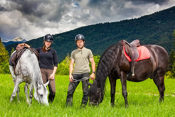 istock Couple With Horses Relaxing In Nature 187139159