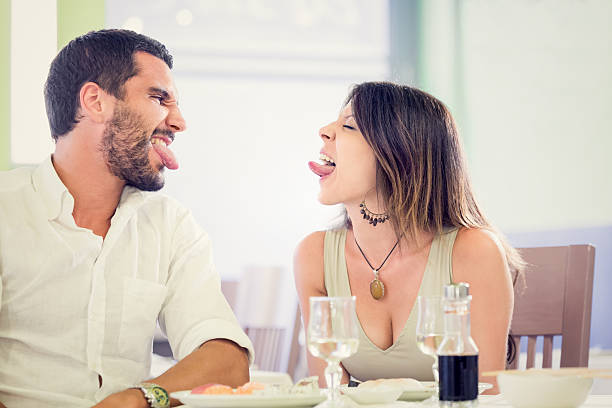 istock Young romantic couple grimacing at restaurant 187139182