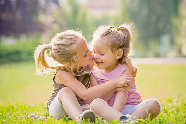 istock Blonde sisters having fun at park 187139218