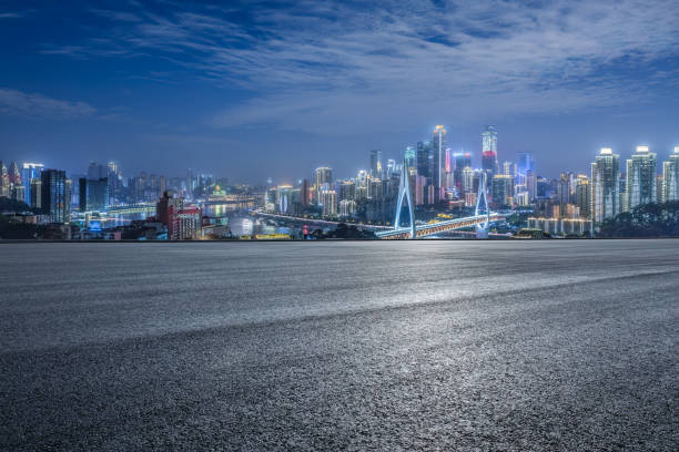istock Empty asphalt road and city buildings skyline 1871393367
