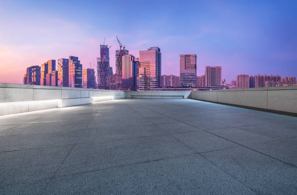istock Empty brick road and city buildings skyline 1871393370
