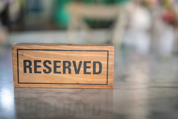 istock Wooden reservation sign on the dining table. 1871411670