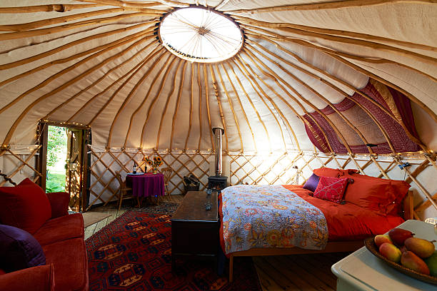 Interior Of Empty Holiday Yurt The rising phenomenon of glamping - glamorous camping yurt photos stock pictures, royalty-free photos & images