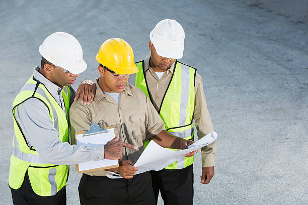 istock Workers in hardhats and safety vests 187142377