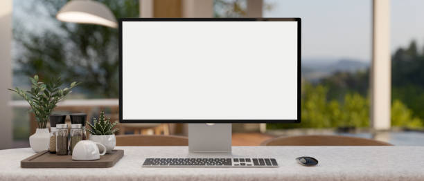 istock Front view image of a PC desktop computer mockup on a desk in a modern, bright room. 1871430530