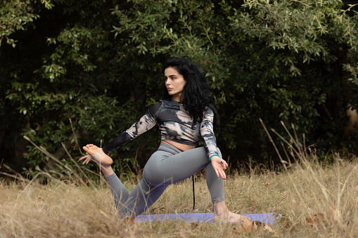 Asian women are practicing yoga on nature.