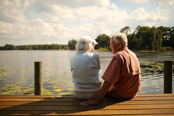 istock Loving Senior Couple Looking At Each Other On Pier 187145621