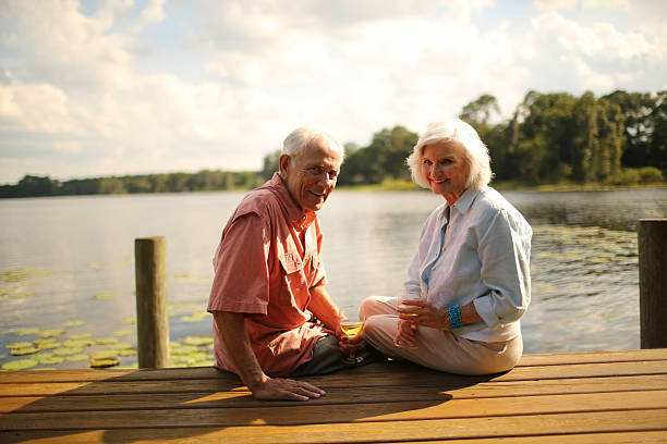istock Senior Couple Enjoying Wine On Pier 187145624