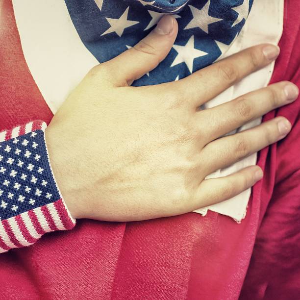 istock American Fan Putting Hand on Hearth During the National Anthem 187145943
