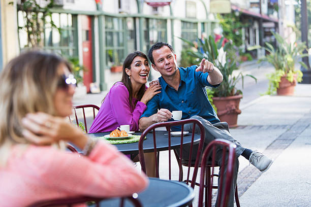 Romantic Hispanic couple (30s, 40s) at an outdoor cafe.