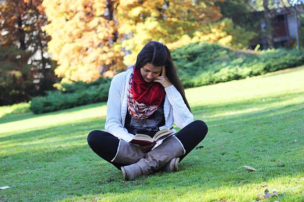 istock girl reading in the nature 187147593