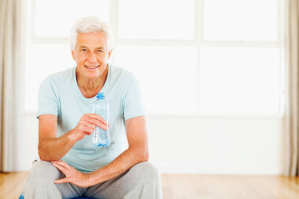 istock Senior Man Holding Water Bottle 187148449