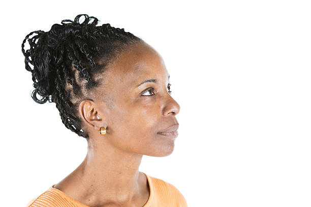 Profile of a Beautiful African American Woman In Her 50's Beautiful African American woman in her mid-50's turned profile to the camera and looking slightly up. braided hair photos stock pictures, royalty-free photos & images
