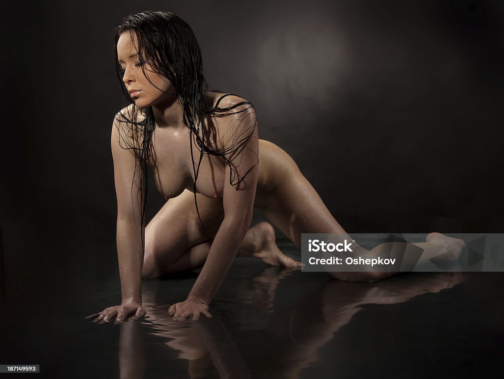 Naked girl in water on a black background Naked girl in water on a black backgroundNaked girl on a glacier Adults Only Stock Photo