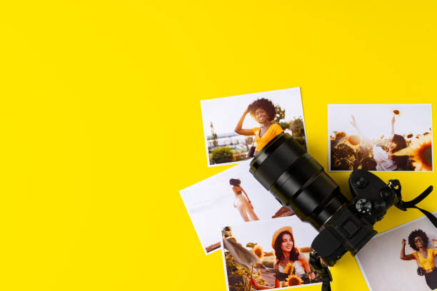 istock Photo camera with colorful printer photos on yellow background 1871509026