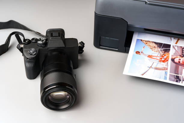 istock Printer and photo camera on table. Printing photos concept 1871517489