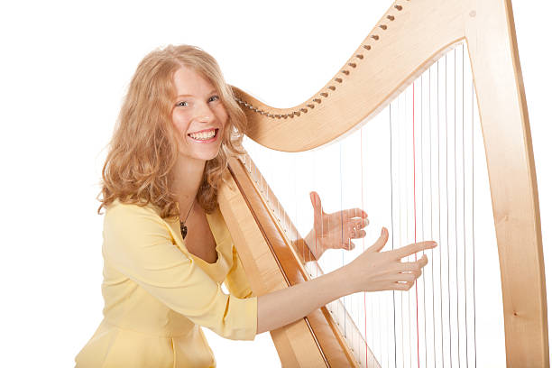 girl in yellow playing the harp
