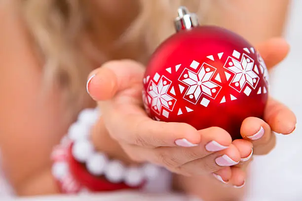 Woman holding bauble up close