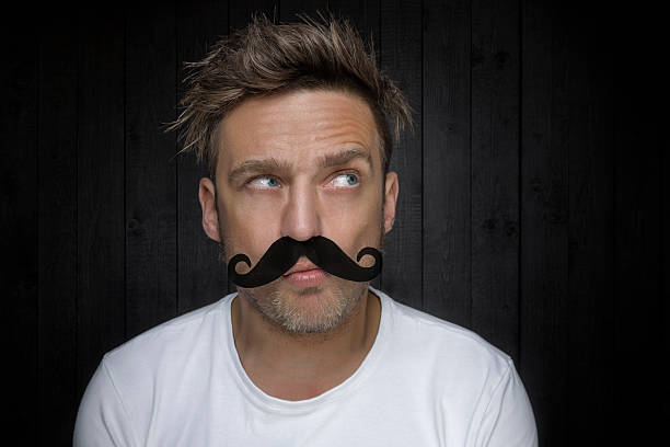 Man with fake mustache stock photo