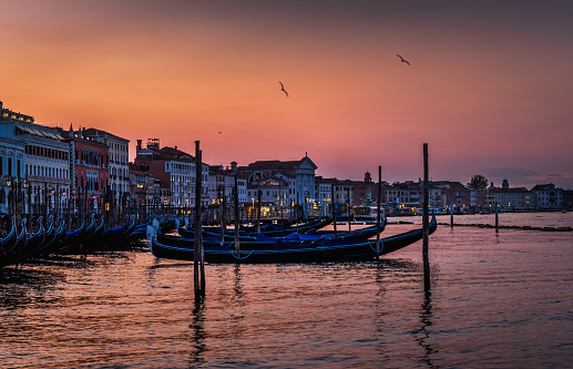 View of gondolas, building and city lights at Grand Canal, Venice, Italy, at sunset