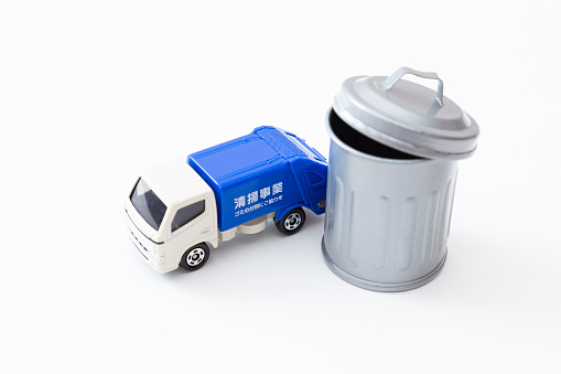 Garbage truck and trash can.