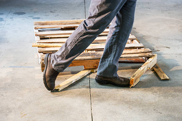istock Man tripping over a damaged pallet 187153633