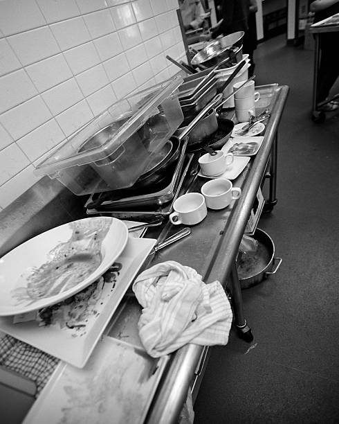 Dirty dishes, pots and pans stock photo