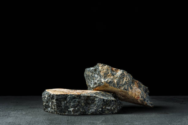 istock Piece of granite stone against black background 1871553487